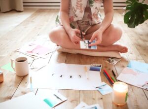 Woman sitting on floor making a vision board
